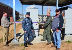 Naval Air Station Whiting Field Commanding Officer Capt. Matthew Coughlin, Public Works Officer Lt. Cmdr. Jason Kranz, and personnel from contract partner Atlantic Contingency Constructors, LLC celebrate the commissioning of the air station's first large-scale photovoltaic power plant. U.S. Navy photo by Lt. j.g. Tim Mosso.